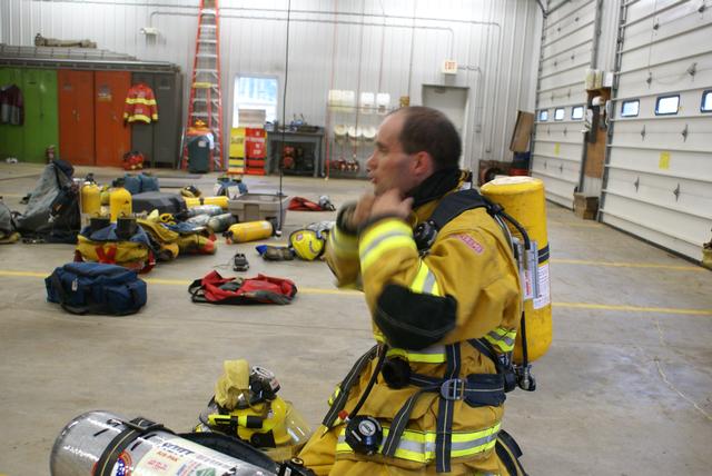 A tired SLVFD member Damon Jacobs removes gear following a search and rescue exercise during Firefighter 1 training at Paul Smith/Gabriels fire station 10/16/2010